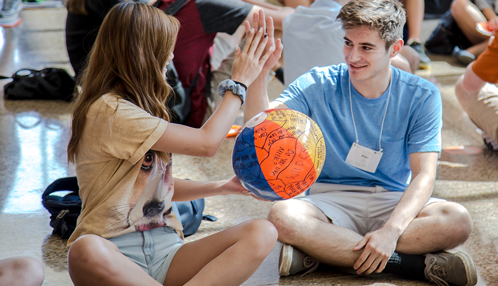 Jade Noland and Alex Prescott give each other high-fives during orientation small group exercises.